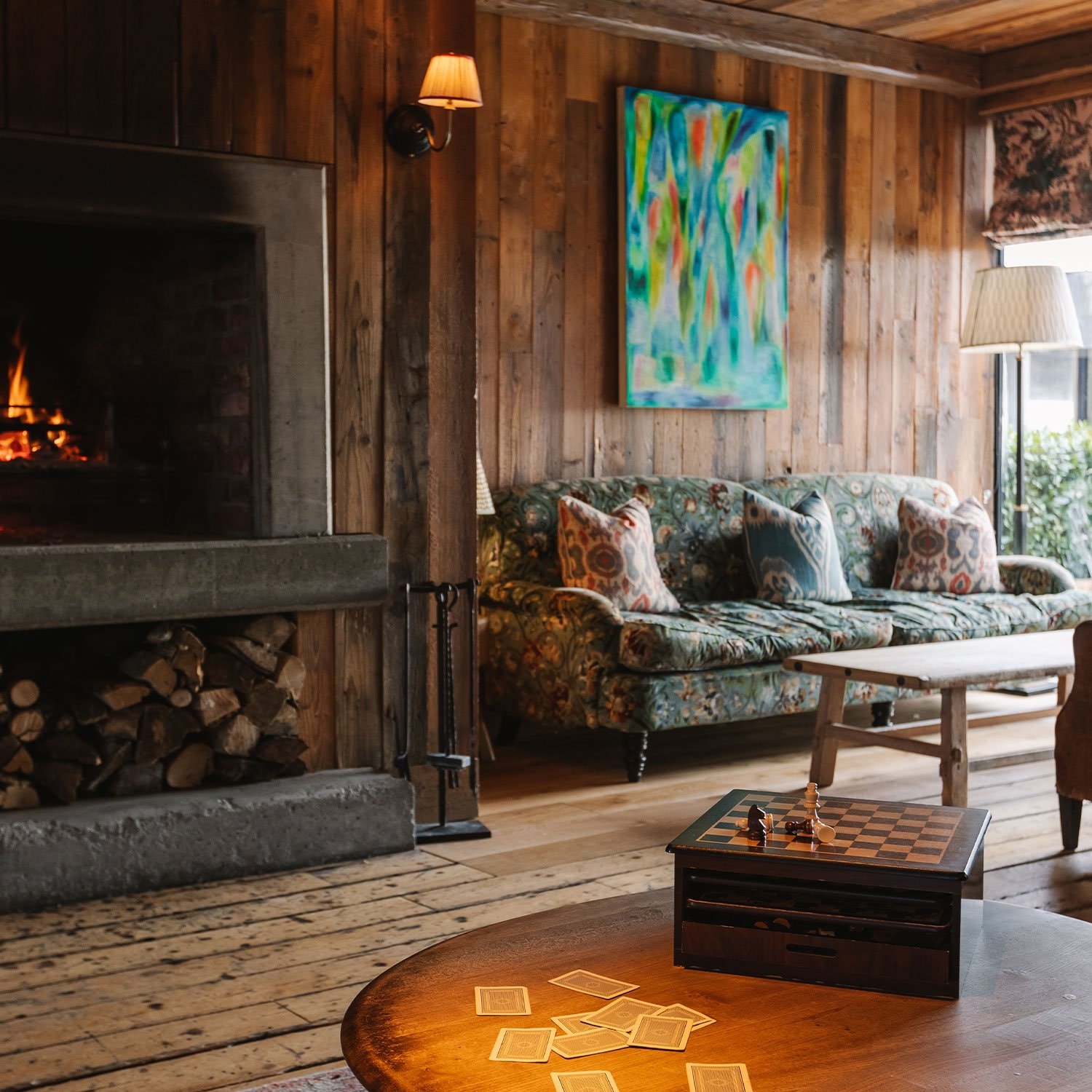 A large room with games, a fireplace, and seating area