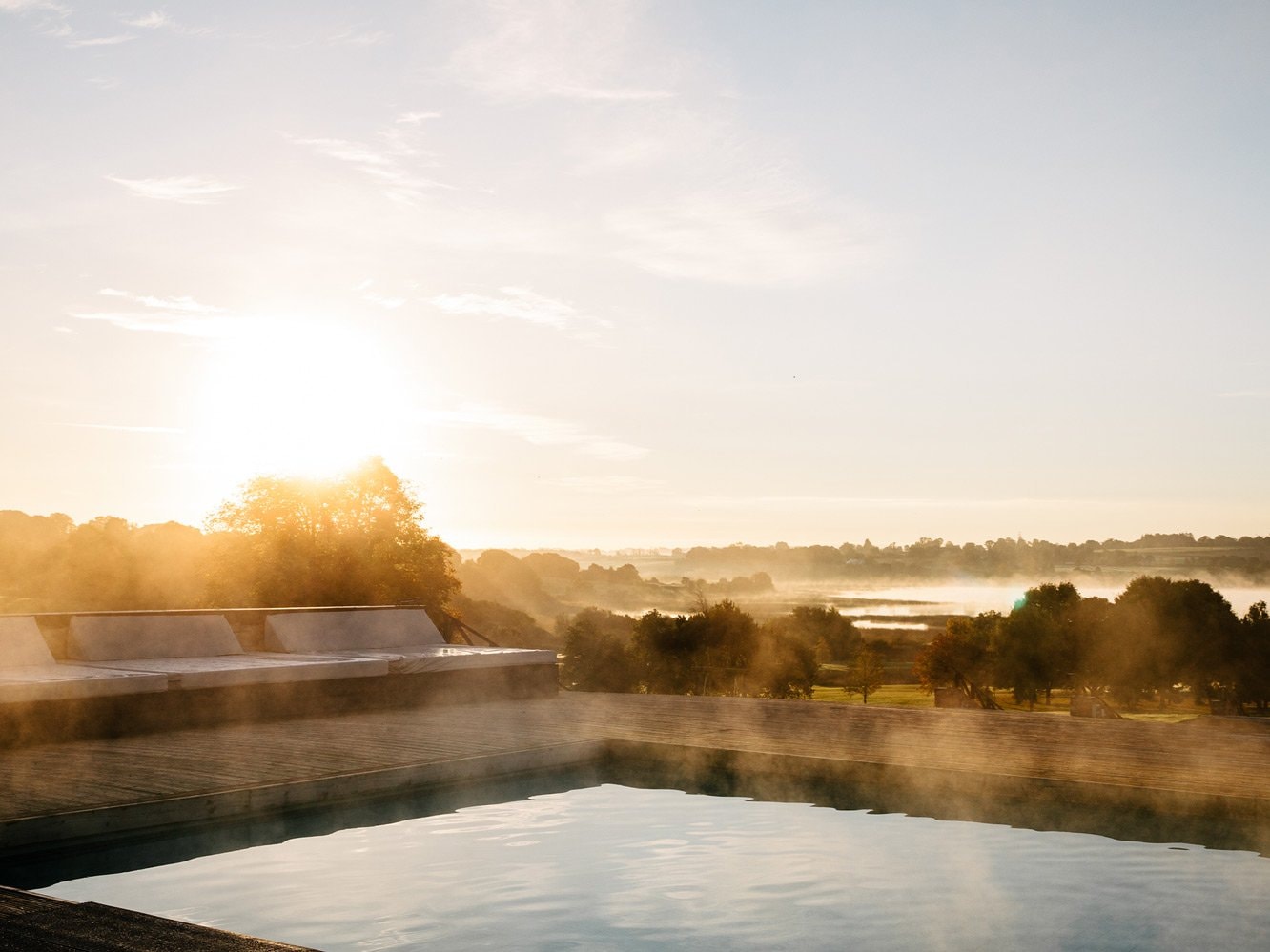 The pool steaming at sunset