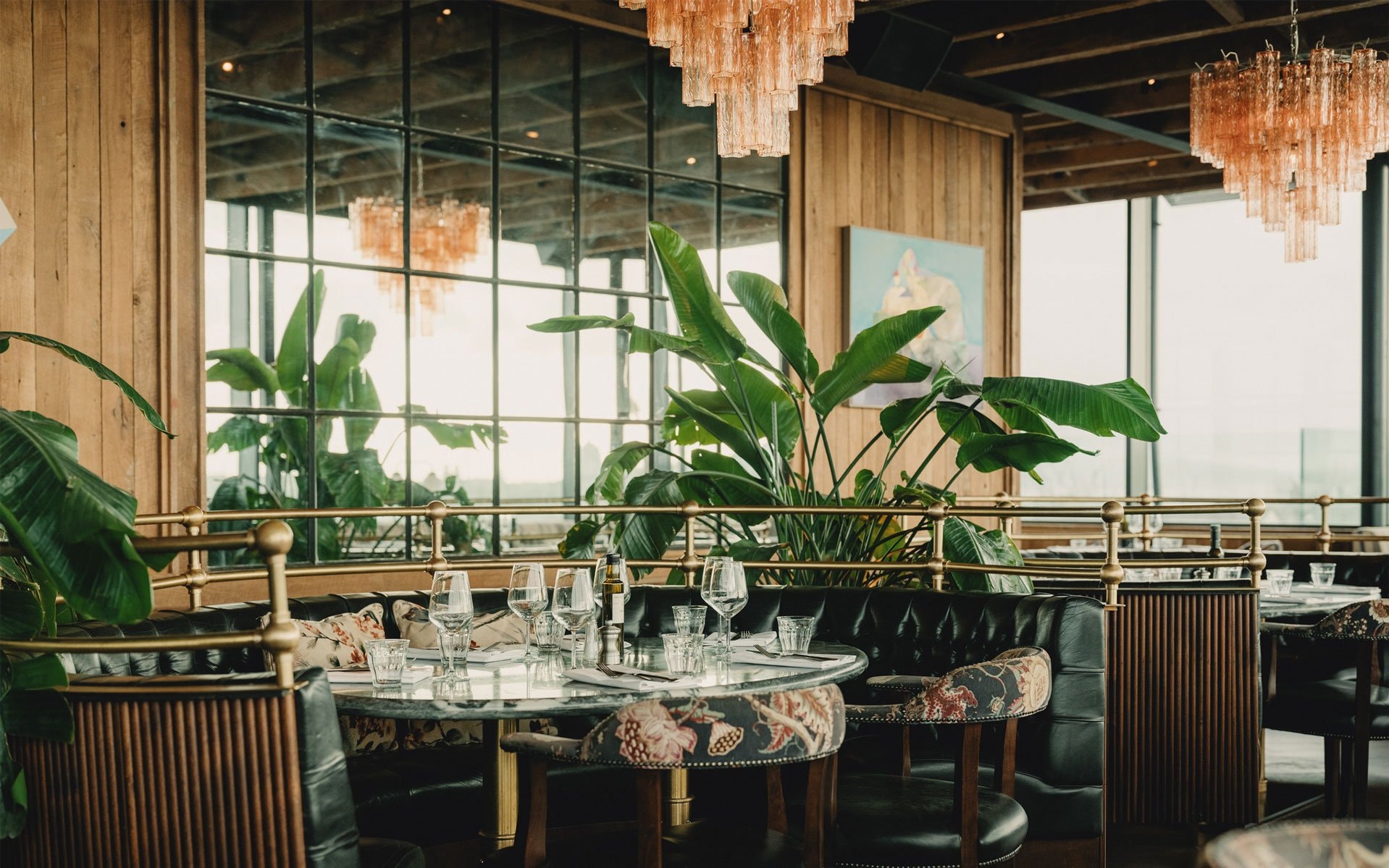 A dining area with rose gold chandeliers