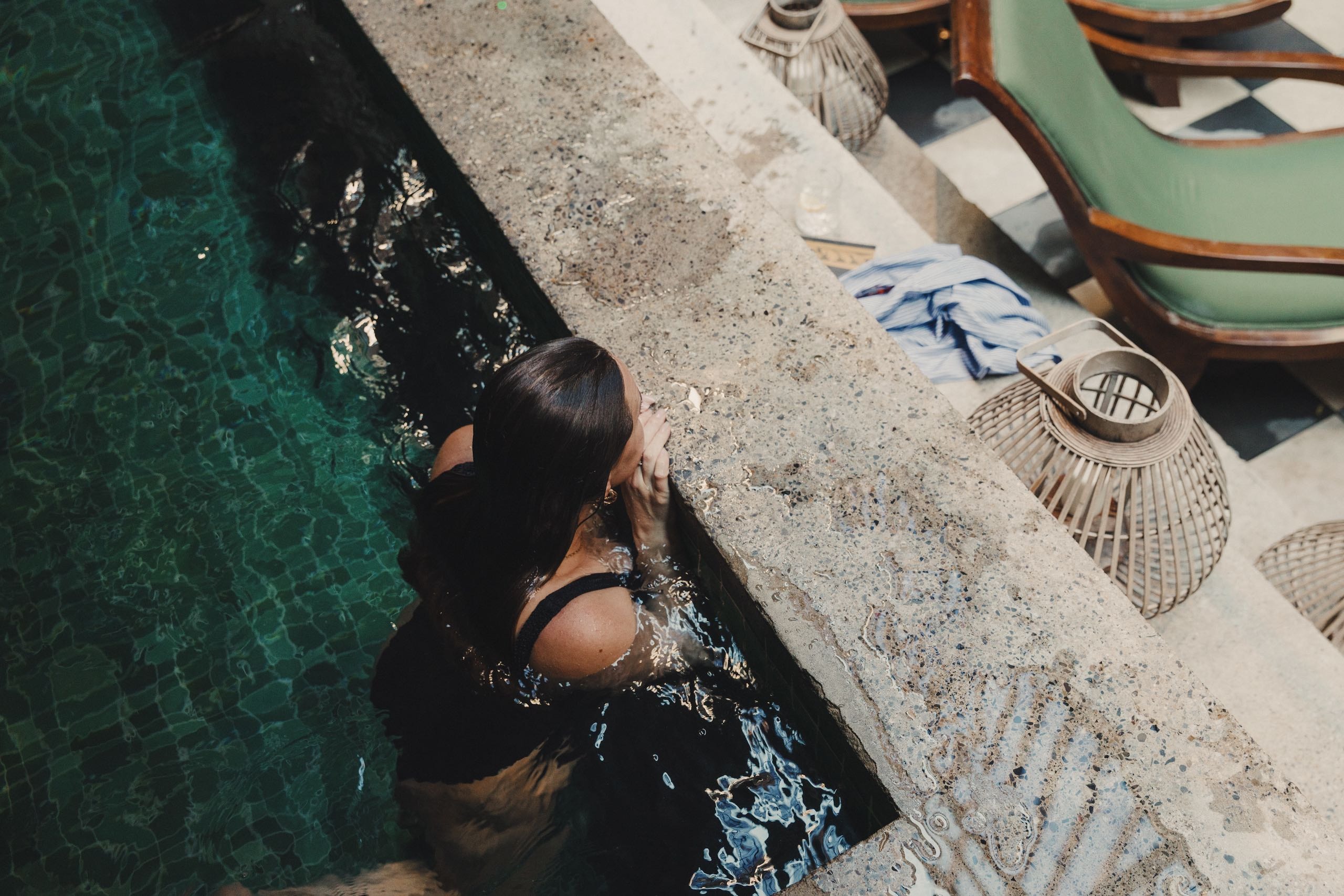 A woman sitting in a pool