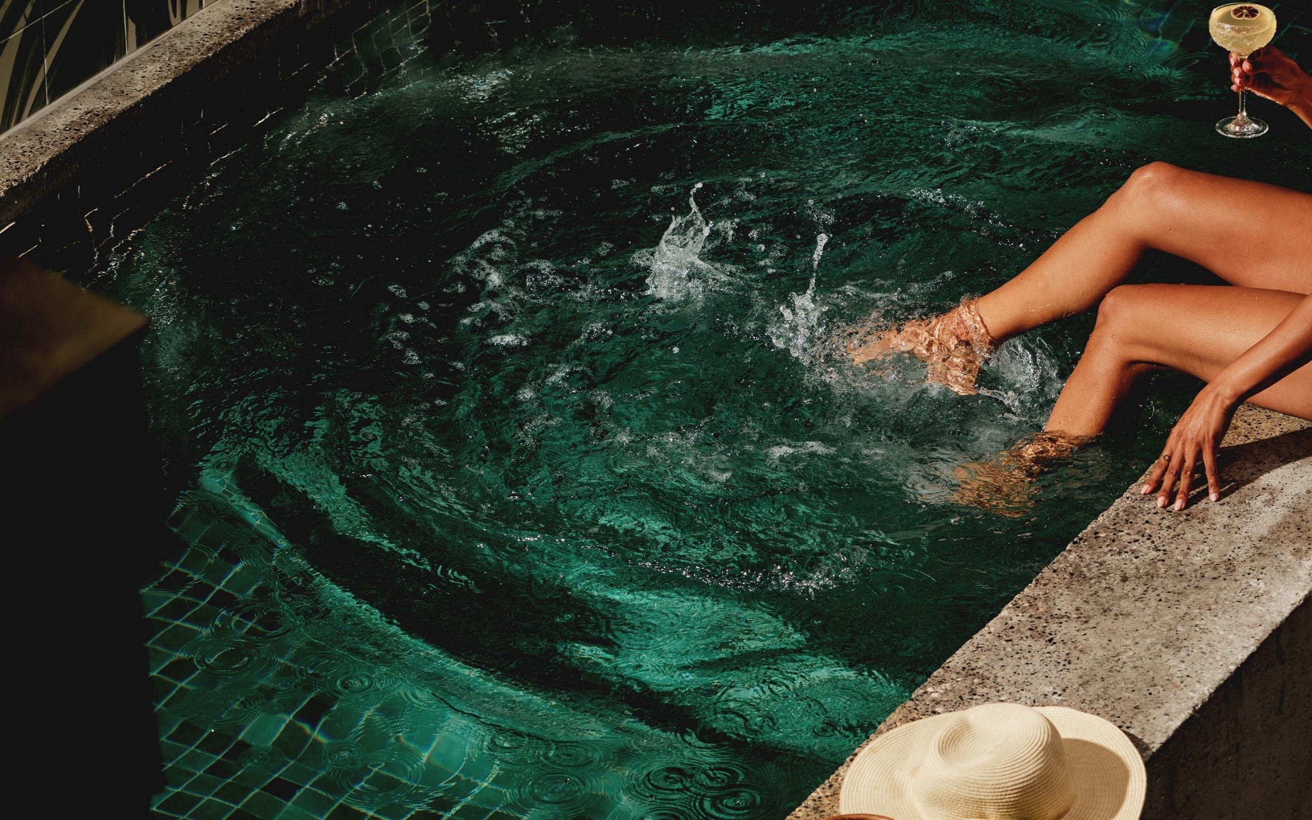 Woman sitting poolside.