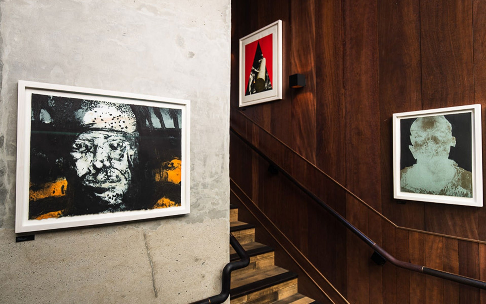 A stairwell with framed artwork