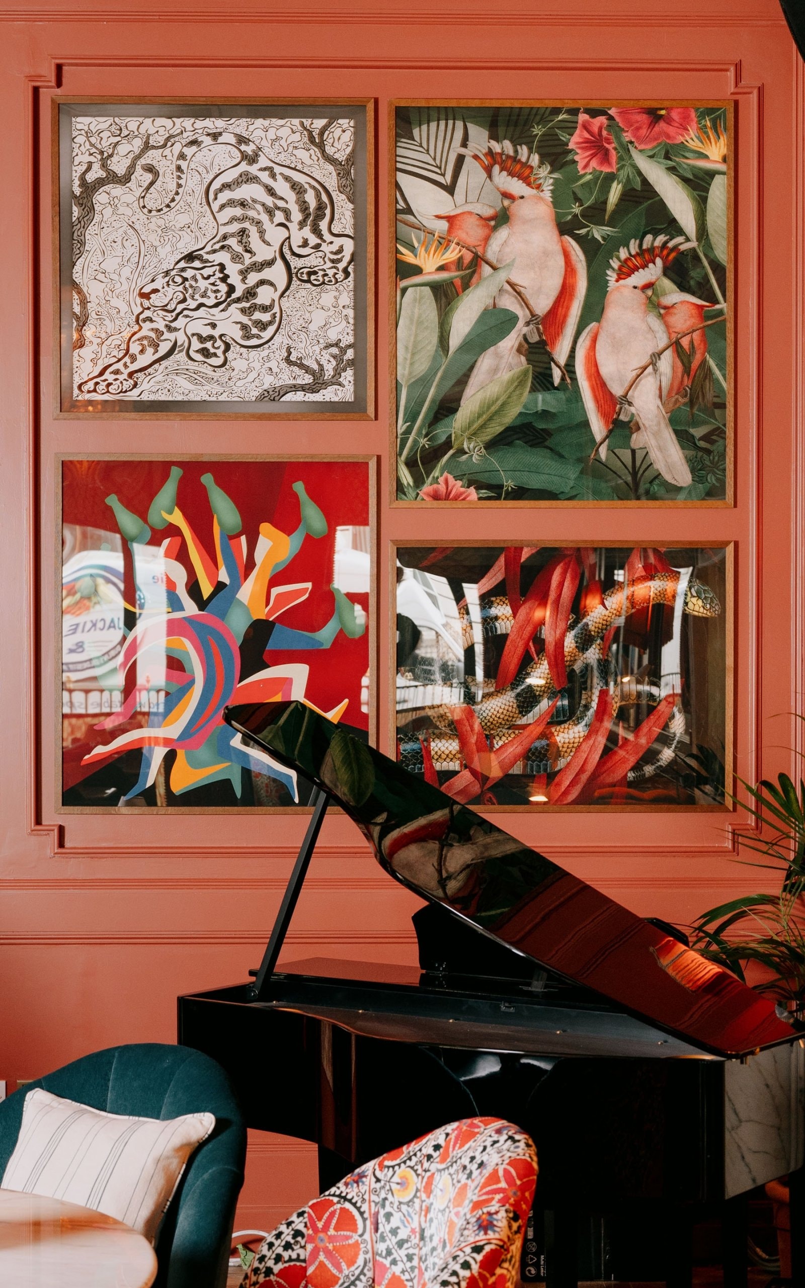 Framed art on wall with a piano in the foreground